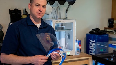 Master Sgt. Justin Pittman, Innovation Lab senior project manager, holds a completed face shield April 7,2020, at Dover Air Force Base, Delaware. The face shields were printed by the 436th Airlift Wing Innovation Lab 'Bedrock' for use by medical and security forces personnel supporting COVID-19 response efforts.