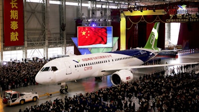 The first COMAC twin-engine, 158-seat C919 passenger plane is pulled out of the company's hangar near the Pudong International Airport, Shanghai, Nov. 2, 2015.