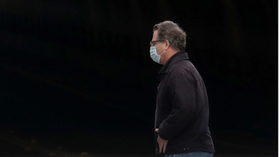 A man wears a mask while crossing in front of the Stockton Street Tunnel in San Francisco, Sunday, March 29, 2020.