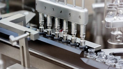 In this March 2020 photo provided by Gilead Sciences, rubber stoppers are placed onto filled vials of the investigational drug remdesivir at a Gilead manufacturing site in the United States. Given through an IV, the medication is designed to interfere with an enzyme that reproduces viral genetic material.
