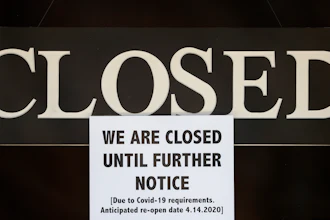 A notice of closure is posted at The Great Frame Up in Grosse Pointe Woods, Mich., Thursday, April 2, 2020. The coronavirus COVID-19 outbreak has triggered a stunning collapse in the U.S. workforce with millions of people losing their jobs in the past two weeks and economists warn unemployment could reach levels not seen since the Depression, as the economic damage from the crisis piles up around the world.