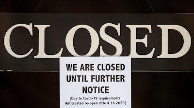 A notice of closure is posted at The Great Frame Up in Grosse Pointe Woods, Mich., Thursday, April 2, 2020. The coronavirus COVID-19 outbreak has triggered a stunning collapse in the U.S. workforce with millions of people losing their jobs in the past two weeks and economists warn unemployment could reach levels not seen since the Depression, as the economic damage from the crisis piles up around the world.