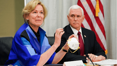 In this March 5, 2020, file photo, Dr. Deborah Birx, Ambassador and White House coronavirus response coordinator, holds a 3M N95 mask as she and Vice President Mike Pence visit 3M headquarters in Maplewood, Minn., in a meeting with the company's leaders and Minnesota Gov. Tim Walz to coordinate response to the COVID-19 coronavirus.