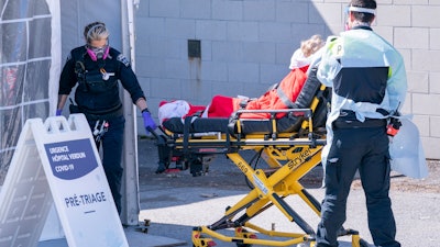 A patient is wheeled into the emergency unit of the Verdun Hospital in Montreal on Monday, April 6, 2020.