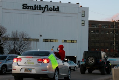 In this April 9, 2020 file photo employees and family members protest outside a Smithfield Foods processing plant in Sioux Falls, S.D.
