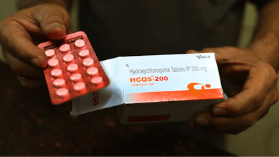 In this Thursday, April 9, 2020 file photo, a chemist displays hydroxychloroquine tablets in New Delhi, India. Scientists in Brazil have stopped part of a study of the malaria drug touted as a possible coronavirus treatment after heart rhythm problems developed in one-quarter of people given the higher of two doses being tested. Chloroquine and a similar drug, hydroxychloroquine, have been pushed by President Donald Trump after some early tests suggested the drugs might curb coronavirus entering cells.