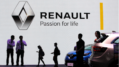 In this April 20, 2017, file photo, visitors walk past the Renault stand during the Auto Shanghai 2017 show in Shanghai, China.