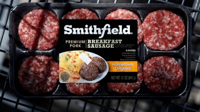 In this April 14 photo, a package of Smithfield Foods breakfast sausage sits in a shopping cart outside of a local grocery story, in Des Moines, IA.