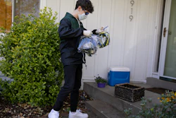 Will Olsen, 17, picks up bags holding pieces for medical face shields that were printed using personal 3D printers, Kensington, Md., April 19, 2020.