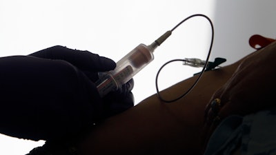 In this April 28, 2015 file photo, a patient has her blood drawn for a liquid biopsy at a hospital in Philadelphia. According to results released on Tuesday, April 28, 2020, for the first time, a blood test has been shown to help detect many types of cancer in a study of thousands of women with no symptoms of the disease. The test is still experimental and even its fans say it needs to be improved.