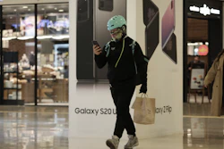 A man passes by an advertisement of Samsung's Galaxy S20 Ultra and Galaxy Z Flip smartphones at its shop in Seoul, April 28, 2020.