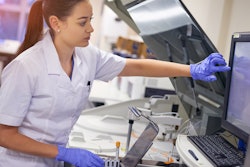 A lab technician using HMI to analyze blood samples.