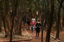 People wearing protective face mask as a precaution against the spread of the new coronavirus jog at Chalputepec park in Mexico City, Sunday, April 26, 2020.