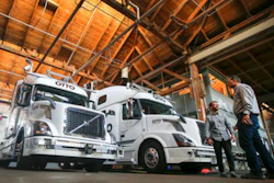 In this Thursday, Aug. 18, 2016, file photo, employees stand next to self-driving, big-rig trucks during a demonstration at the Otto headquarters, in San Francisco. Uber's self-driving startup Otto developed technology allowing big rigs to drive themselves. After taking millions of factory jobs, robots could be coming for a new class of worker: people who drive for a living.