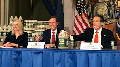 New York Gov. Andrew Cuomo, right, introduces a hand sanitizer manufactured by the state of New York.