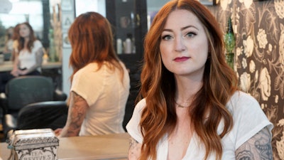 Hairstylist Lacey Ward poses for a photo at the Grey House Salon she co-owns, in Omaha, Neb., Thursday, April 30, 2020.