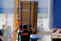 Civil protection workers move boxes of ventilators at the customs post in Sarajevo, April 30, 2020.