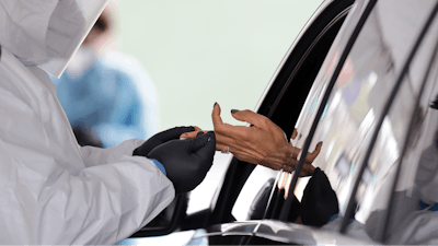 In this April 14, 2020 file photo, a woman holds her hand out to have blood collected for COVID-19 antibodies at a drive-thru site in Hempstead, N.Y. U.S. regulators on Monday, May 4 pulled back a decision that allowed scores of coronavirus blood tests to hit the market without first providing proof that they worked. The Food and Drug Administration said it took the action because some sellers have made false claims about the tests and their accuracy.