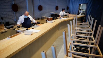 Kissaki chef Mark Garcia prepares sushi meals for delivery to Mount Sinai Medical Center, May 5, 2020, in New York.