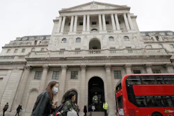 Pedestrians pass the Bank of England in London, March 11, 2020.
