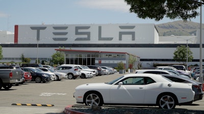 Vehicles are seen parked at the Tesla car plant.