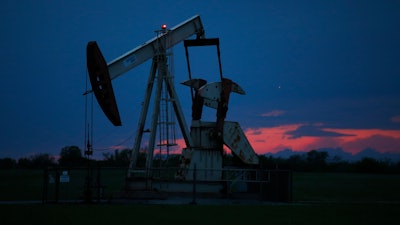 In this April 21, 2020 file photo, a pumpjack is pictured as the sun sets in Oklahoma City. Google says it won’t build custom artificial intelligence tools for speeding up oil and gas extraction, taking an environmental stance that distinguishes it from cloud computing rivals Microsoft and Amazon. The announcement followed a Greenpeace report on Tuesday, May 19, that documents how the three tech giants are using AI and computing power to help oil companies find and access oil and gas deposits in the U.S. and around the world.
