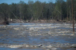 Floodwaters rush through the path of where the Edenville Dam once stood north of Midland, Mich., May 20, 2020.