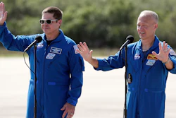 NASA astronauts Bob Behnken, left, and Doug Hurley wave as they leave a news conference at the Kennedy Space Center in Cape Canaveral, Fla., May 20, 2020.