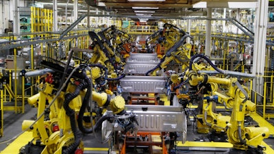 In this Sept. 27, 2018 file photo, robots weld the bed of a 2018 Ford F-150 truck on the assembly line at the Ford Rouge assembly plant in Dearborn, Mich.