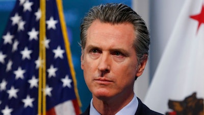 In this April 9, 2020, file photo, California Gov. Gavin Newsom listens to a reporter's question during his daily news briefing in Rancho Cordova, Calif. California's major deal for hundreds of millions of N95 respirator masks hit a delay in its federal certification process, Gov. Gavin Newsom said Wednesday, May 6, 2020, as he promised details of the contract would soon be made public.