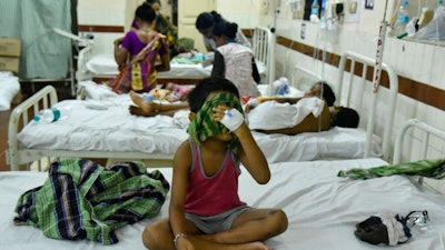 Children receive treatment at a hospital following a chemical gas leak in Vishakhapatnam, India, Friday, May 8, 2020. Indian authorities evacuated more people from villages near a South Korean-owned chemical factory where a gas leak killed 12 people and left about 1,000 struggling to breathe. Authorities said the evacuation was precautionary, but it triggered panic among people overnight that another gas leak was occurring.