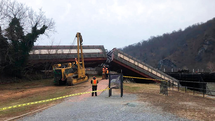 This Dec. 21, 2019 file photo photo provided by the Washington County, Md., shows a freight line train in the Potomac River near Harpers Ferry, W.Va. A report from the Federal Railroad Administration says an engineer error caused a CSX freight train to derail as it crossed the Potomac River near Harpers Ferry, West Virginia. The derailment in December sent two cars into the water and damaged a footbridge that is part of the Appalachian Trail