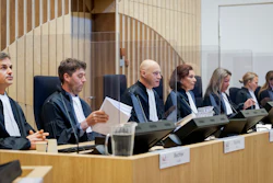 Presiding judge Hendrik Steenhuis, third from left, opens the court session as the trial resumed at the high security court building at Schiphol Airport, near Amsterdam.