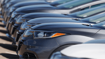 In this file photo dated Sunday, June 7, 2020, a long row of unsold cars at a Honda dealership in Highlands Ranch, USA.