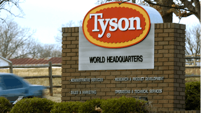 In this Jan. 29, 2006, file photo, a car passes in front of a Tyson Foods Inc., sign at Tyson headquarters in Springdale, Ark.