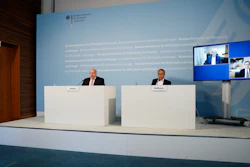 German Economy Minister Peter Altmaier, left, state secretary at the economic ministry Ulrich Nussbaum, right, attend a news conference with investor Dietmar Hopp, screen left, and CureVac CEO Franz-Werner Haas, screen right, in Berlin, June 15, 2020.