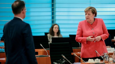 German Chancellor Angela Merkel and German Foreign Minister Heiko Maas attend the weekly cabinet meeting at the chancellery in Berlin, Germany on Wednesday, June 24.