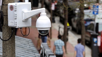 In this April 14, 2014, file photo, a surveillance camera is attached to a light pole along Boylston Street in Boston. The Boston City Council voted unanimously, Wednesday, June 24, 2020, to pass a ban on the use of facial recognition technology by city government.