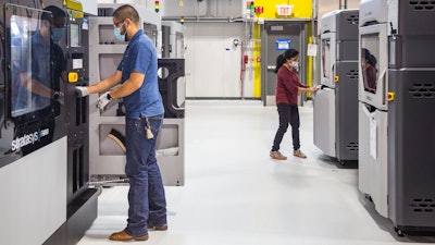 General Motors additive manufacturing team members working at the still-under-construction Additive Innovation Center.