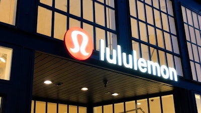 This Feb. 20, 2020 file photo shows a Lululemon sign in Burlingame, Calif. Athletic apparel maker Lululemon Athletica Inc. said Monday, June 29, 2020 it's acquiring at-home exercise startup Mirror for $500 million. The deal is part of Lululemon's plan to expand beyond just selling yoga tights and other workout clothing.