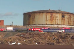 In this image taken from video provided by the RU-RTR Russian television on Wednesday, June 3, 2020, Russian Emergency Situations Ministry trucks work at the scene of an oil spill at a power plant in an outlying section of the city of Norilsk, 2900 kilometers (1800 miles) northeast of Moscow, Russia. Russian President Vladimir Putin has declared a state of emergency in a region of Siberia after an estimated 20,000 tons of diesel fuel spilled from a power plant storage facility and fouled waterways.
