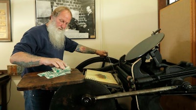 The small town of Tenino, Washington, issued wooden currency, being printed here on an 1890s-era press, to help residents and local merchants alike get through the economic fallout of the coronavirus pandemic.