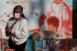 A woman waits to get tested for COVID-19 at a mobile diagnostic tent in San Gregorio Atlapulco, Xochimilco, Mexico City, July 22, 2020.