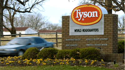 In this Jan. 29, 2006, file photo, a car passes in front of a Tyson Foods Inc., sign at Tyson headquarters in Springdale, Ark.