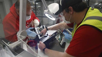 Ford Motor Co. employees work on a ventilator at the Rawsonville plant, Ypsilanti Township, Mich., May 13, 2020.