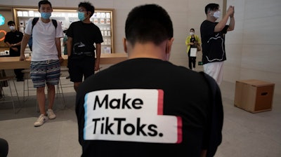A man wearing a shirt promoting TikTok at an Apple store in Beijing, July 17, 2020.