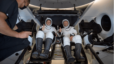 The SpaceX Crew Dragon Endeavour spacecraft is lifted onto the SpaceX GO Navigator recovery ship shortly after it landed with NASA astronauts Robert Behnken and Douglas Hurley onboard in the Gulf of Mexico.