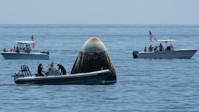 Support teams and curious boaters after the SpaceX Crew Dragon Endeavour spacecraft landed off the coast of Pensacola, Fla., Aug. 2, 2020.