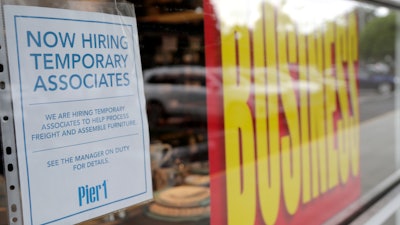 A sign advertises hiring of temporary associates at a Pier 1 retail store in Coral Gables, Fla., Aug. 6, 2020.