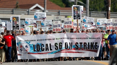 Striking Bath Iron Works shipbuilders march in solidarity.